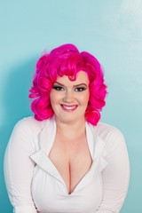 Portrait of a young woman with pink dyed hair over colored background