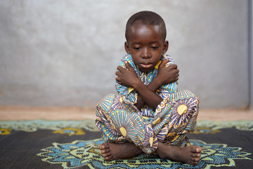 Sad little African boy feels sad, in despair and lonely