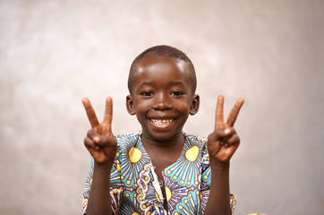 Peace for the world! Little African Black Boy holding up Two Fingers