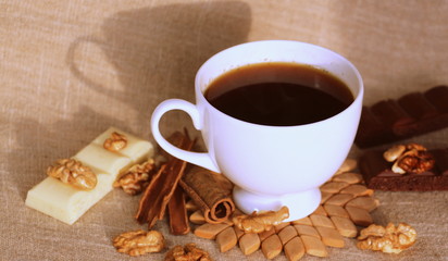 A cup of coffee. White dishes. Coffee and chocolate. Morning ritual.