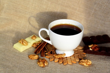 A cup of coffee. White dishes. Coffee and chocolate. Morning ritual.