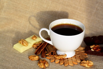 A cup of coffee. White dishes. Coffee and chocolate. Morning ritual.