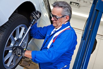 Car mechanic working on car tire