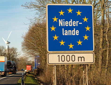 A road border sign stands on the Germanic border of Holland, it means that Holland is one kilometer
