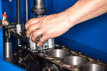 Car engine repair at the factory and parts after disassembly.