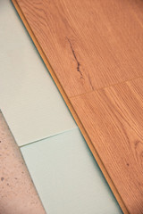 instaling floor laminate flooring with texture hardwood, top view.