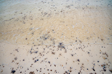 Silent sea waves crashing on a beach at Phi Phi Islands in Thailand.