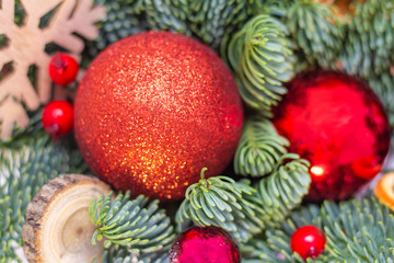 Christmas background composition. Christmas decorations, fir branches with red balls, wooden snowflake. New Year.