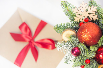 Christmas composition. Christmas decorations, fir branches, envelope with a red ribbon. copy space