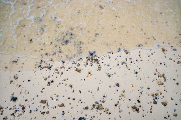 Silent sea waves crashing on a beach at Phi Phi Islands in Thailand.