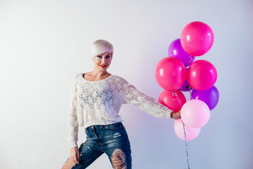 Portrait of a beautiful woman with balloons and holiday gifts