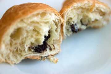 Broken in half croissant with chocolate closeup