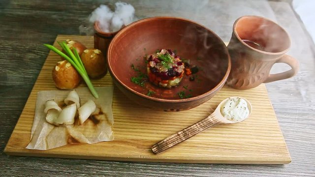 wooden tray with originally decorated ukrainian borscht and doughnuts