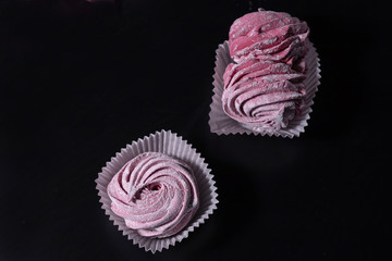 close-up of delicate fruit and berry marshmallows (zephyr) on a dark background