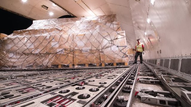 Time lapse loading and unloading cargo inside cargo plane	
