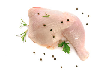 Top view of a fresh chicken drumstick with spices: parsley, pepper, allspice and rosemary on a white background