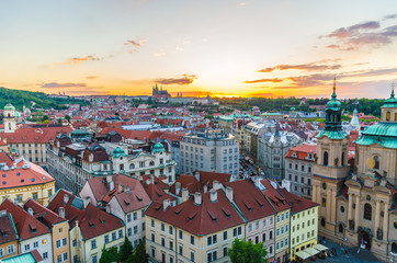 Fototapeta na wymiar Top aerial panoramic view of Prague Old Town historical city centre with red tiled roof buildings and Prague Castle, St. Vitus Cathedral in Hradcany district in evening sunset, Bohemia, Czech Republic