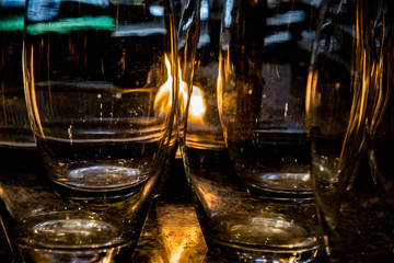 Abstract background of glossy transparent glass textures with flaming fire reflections inside. Unusual shapes and curved lines backdrop. Warm and shiny structure closeup