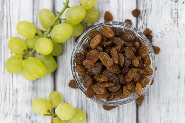 Portion of fresh Raisins on an old wooden table