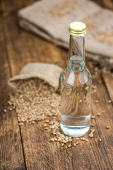 Obraz na płótnie Canvas Portion of fresh Wheat Liqueur on an old wooden table