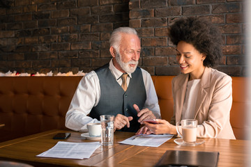 A CEO and a manager having a pleasant meeting discussing the next step in their business venture.