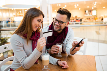 A lady teasing her sweetheart whether or not she'll buy something to him.