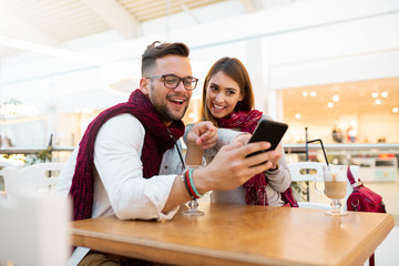 A couple goofing with a phone.