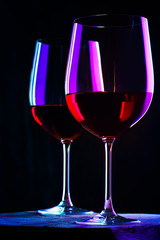 Two glasses of red wine. Intimate atmosphere. Romance concept