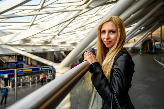 Close up portrait of a trendy young woman waiting for something or somebody at the train station in London, United Kingdom