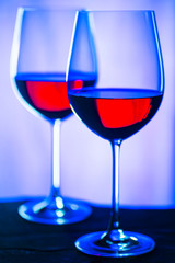 Two glasses of red wine. Intimate atmosphere. Romance concept