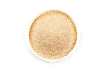 Semolina in bowl, isolated on white background