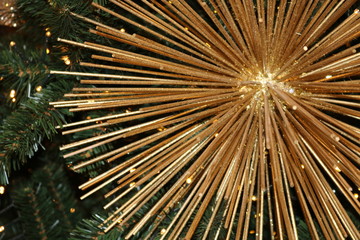 Christmas fuzzy texture of different sharpness of gold sticks and green artificial fir branches with Golden lights. 