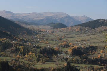 Fototapeta na wymiar Colorful autumn landscape in the mountain village. 