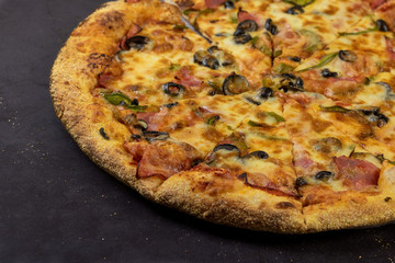 Traditional Italian pizza on a dark background. Top view. Rustic style.