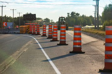 Temporary road cones and lane markings create leading lines as construction and resurfacing work...