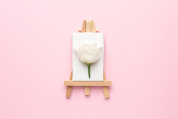 Canvas for painting with white eustoma flower on pink background, spring and creativity concept