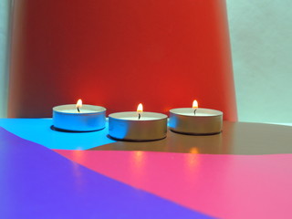 candles on abstract background.candlelight on a multicolored background.