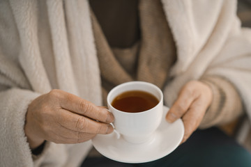 Female Hands Holding A White Cup With Hot Tea