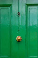 Fototapeta premium House number 8 on an elegant green wooden front door