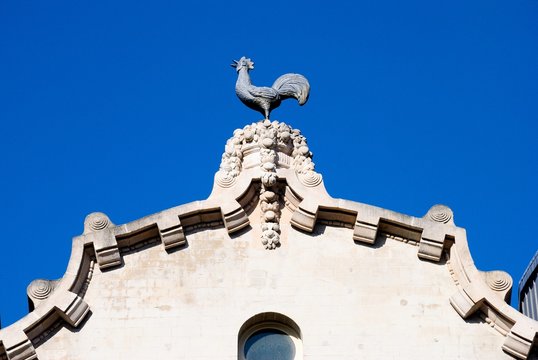 A little stone rooster on the roof of a medieval house in Brussels Old Town area in Belgium