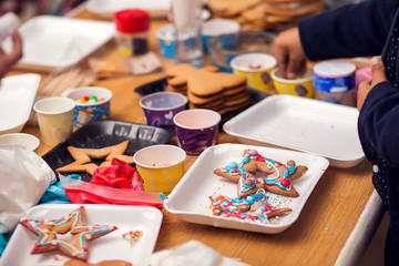 Children doing christmas decoration with hand made cookies