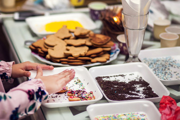 Children doing christmas decoration with hand made cookies