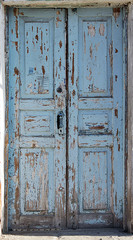 Old weathered blue painted wooden door. 