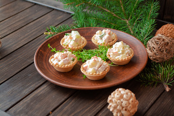 Russian traditional salad in tartlets for holiday New Year table.