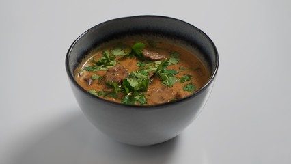 Hungarian mushroom soup on a white table     