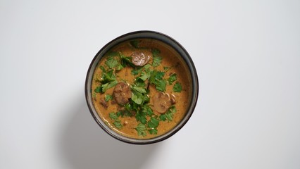 Hungarian mushroom soup on a white table     