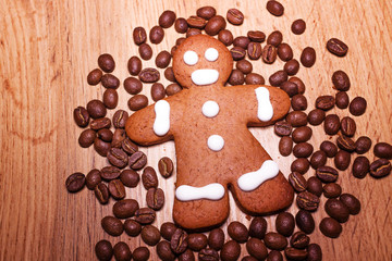 Cookies with coffee in the shape of a man on a wooden background