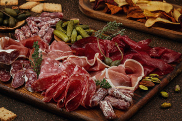 Appetizers table with differents antipasti, cheese, charcuterie, snacks and wine. Sausage, ham,...