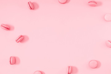 Pink macaroons on pink background. Sweet background. Flat lay, top view, copy space 