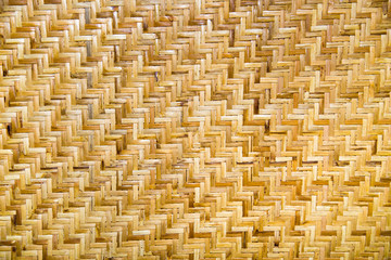 Background of woven rattan anthracite yellow and white with a beautiful pattern in the form of a ladder. Backgrounds, design, structures, textures.